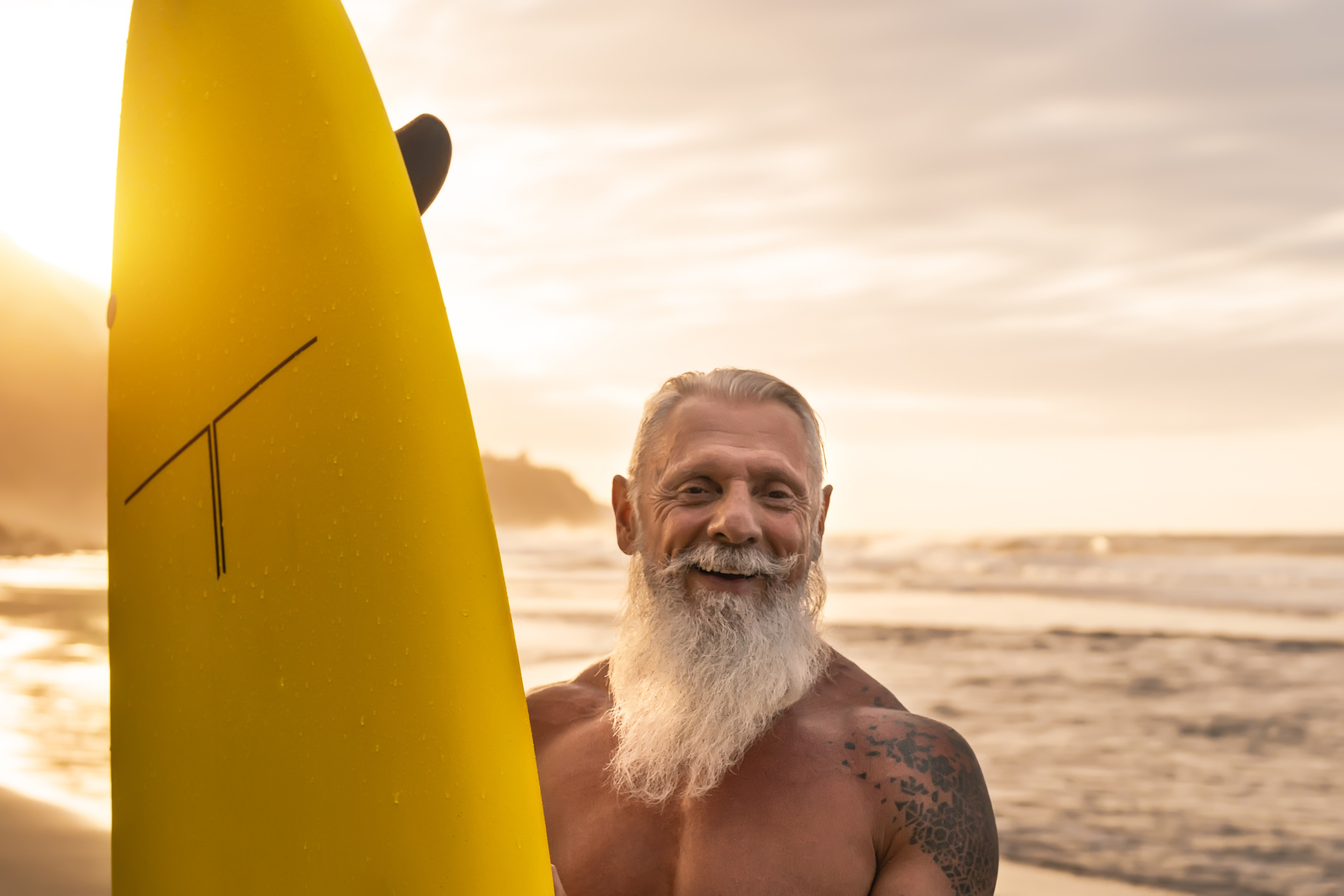 Happy Fit Senior Surfing at Sunset Time